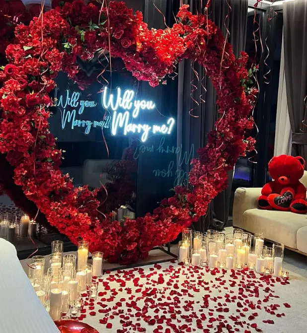 Romantic Proposal Setup with Heart-Shaped Floral Arch