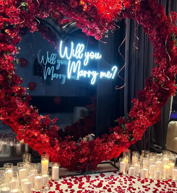 Romantic Proposal Setup with Heart-Shaped Floral Arch - Image 2