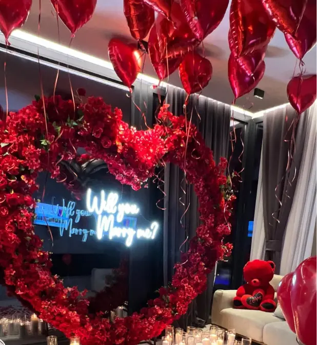 Romantic Proposal Setup with Heart-Shaped Floral Arch - Image 3