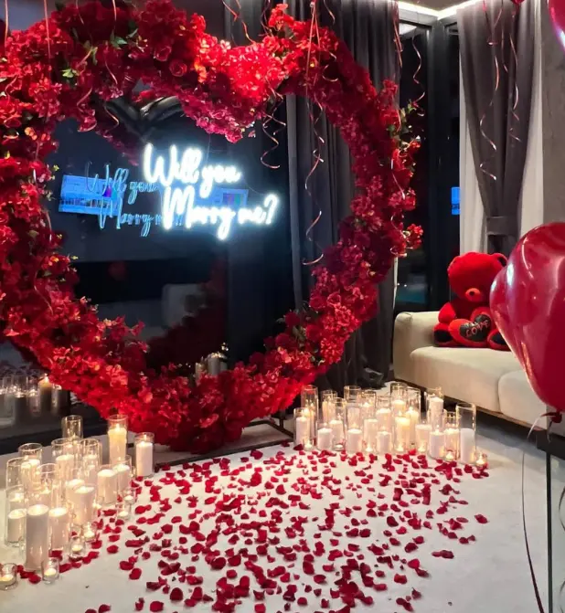 Romantic Proposal Setup with Heart-Shaped Floral Arch - Image 4
