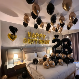Luxury black and gold birthday room decoration with balloons, happy birthday foil letters, and age number balloons