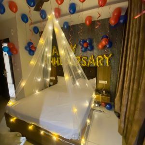 Anniversary room decoration with balloons, fairy lights canopy and happy anniversary foil backdrop
