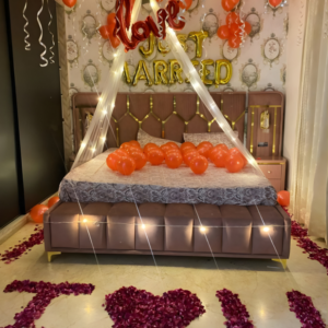 Just married room decoration with balloons, fairy lights canopy and I Love You rose petal decoration