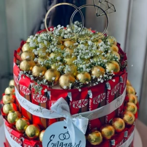 Engagement themed KitKat chocolate bouquet cake with golden chocolates and engagement ring topper