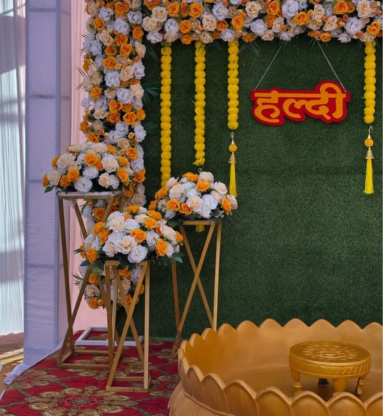 Royal Lotus Haldi decoration with floral backdrop, marigold hangings and golden lotus stage