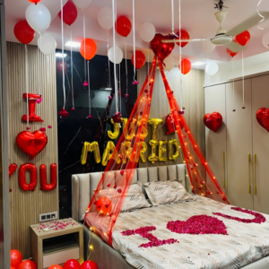 Romantic Just Married bedroom decoration with balloons, rose petals and canopy lights