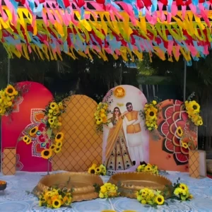 Outdoor Haldi Ceremony Decoration with Colorful Backdrop, Sunflower Floral Styling and Ribbon Canopy