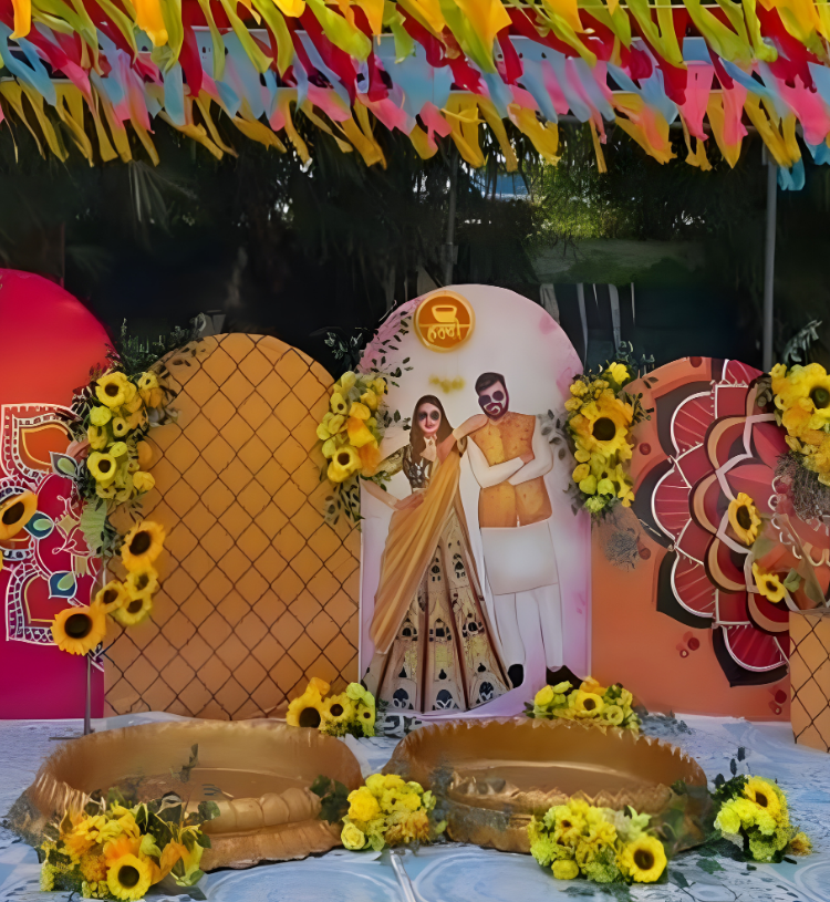 Outdoor Haldi Ceremony Decoration with Colorful Backdrop, Sunflower Floral Styling and Ribbon Canopy