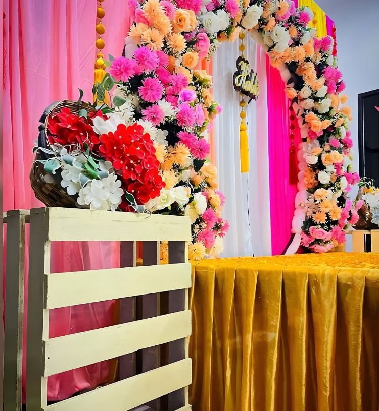 Luxury Haldi Ceremony Stage Decoration with Floral Ring Backdrop and Colorful Drapes