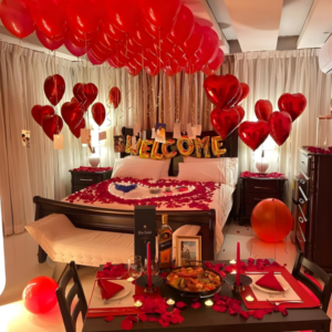 Romantic welcome room decoration with balloons on ceiling, heart balloons, rose petal bed decor and candlelight dinner table